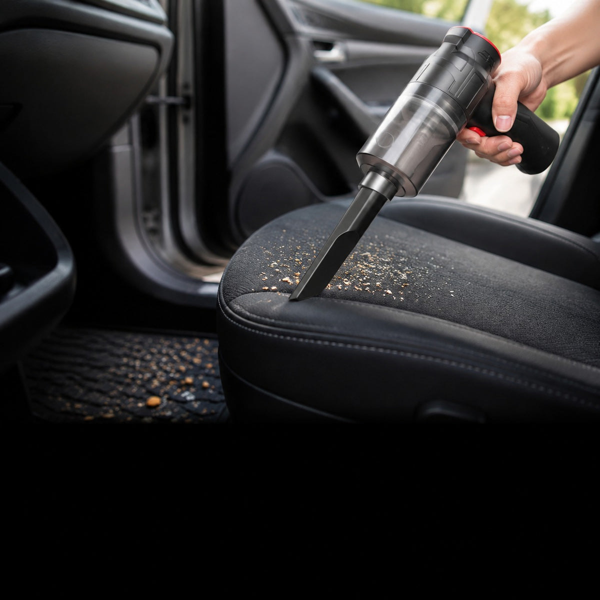 Mini Vacuum held in one hand inside a car door