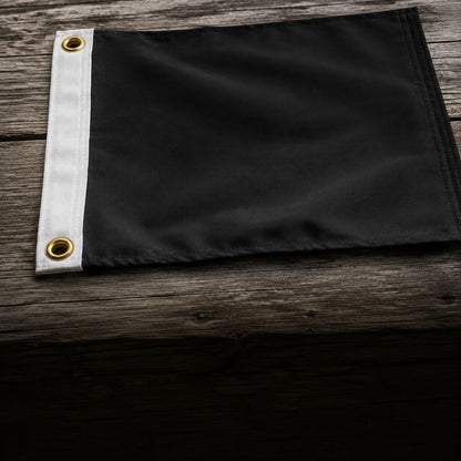 Close view of the canvas header strip and a brass grommet on the black nylon