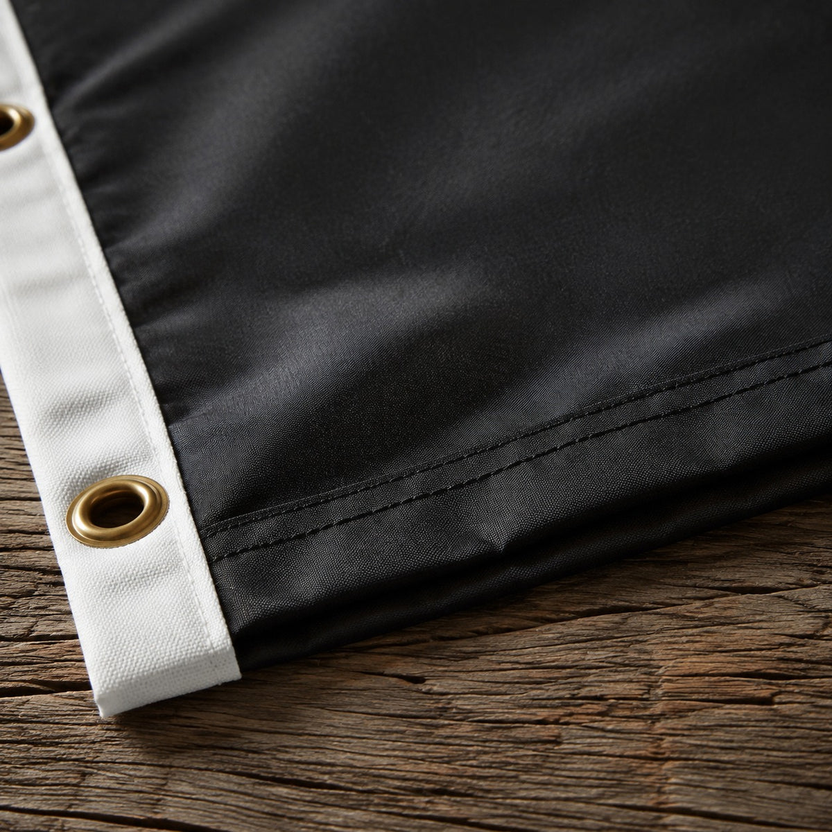 Close view of the stitched hem along the fly end of the black nylon flag