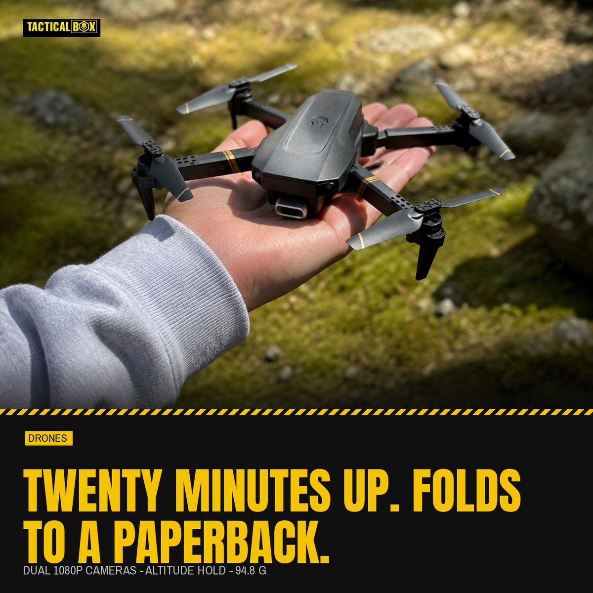 TacRight RC Drone held on an open palm in a mossy clearing with the flight-time figures alongside