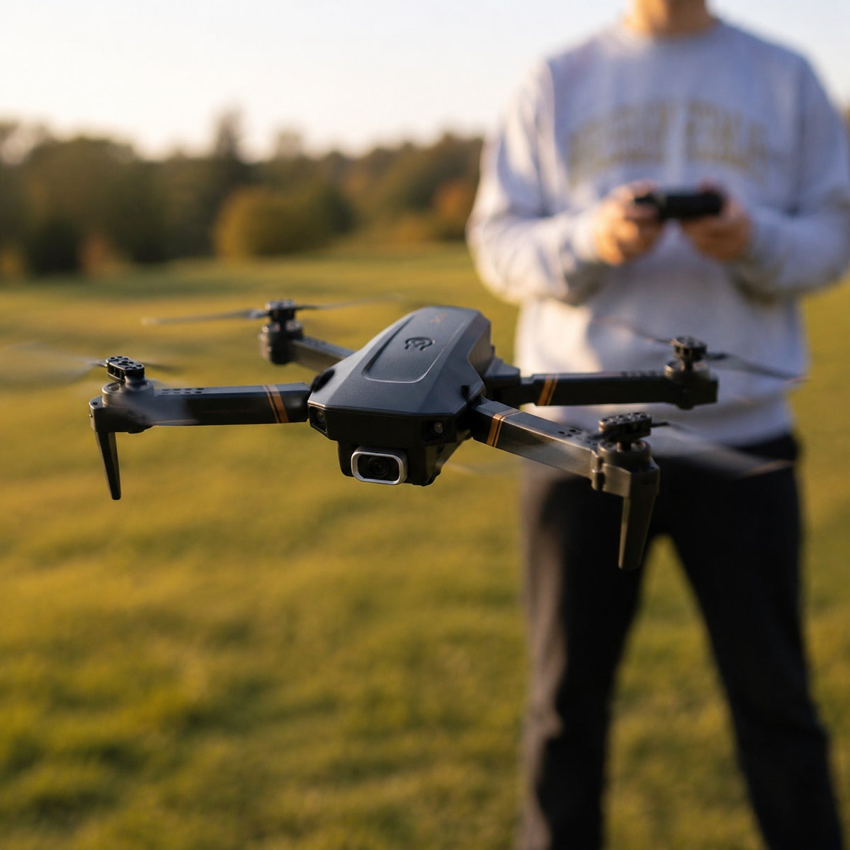 TacRight RC Drone hovering above a grass field at golden hour