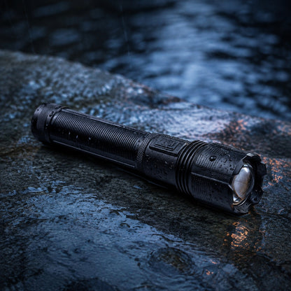 Novalite XPH-50 flashlight on wet rock at dusk with water beading on the barrel