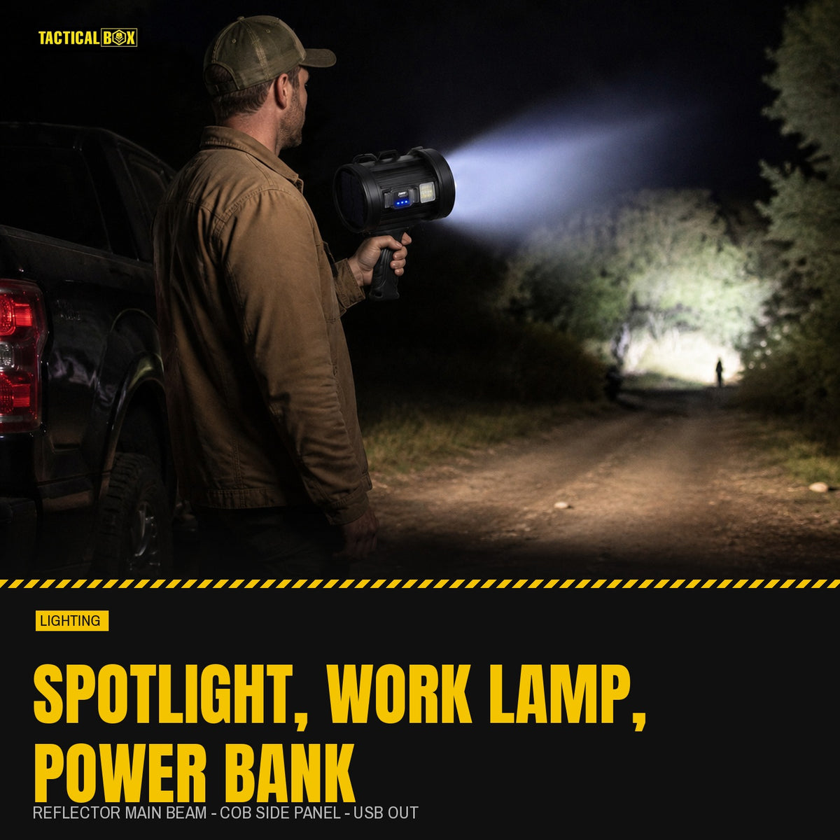 Outdoor Searchlight held beside a pickup at night with the main beam down a dirt track