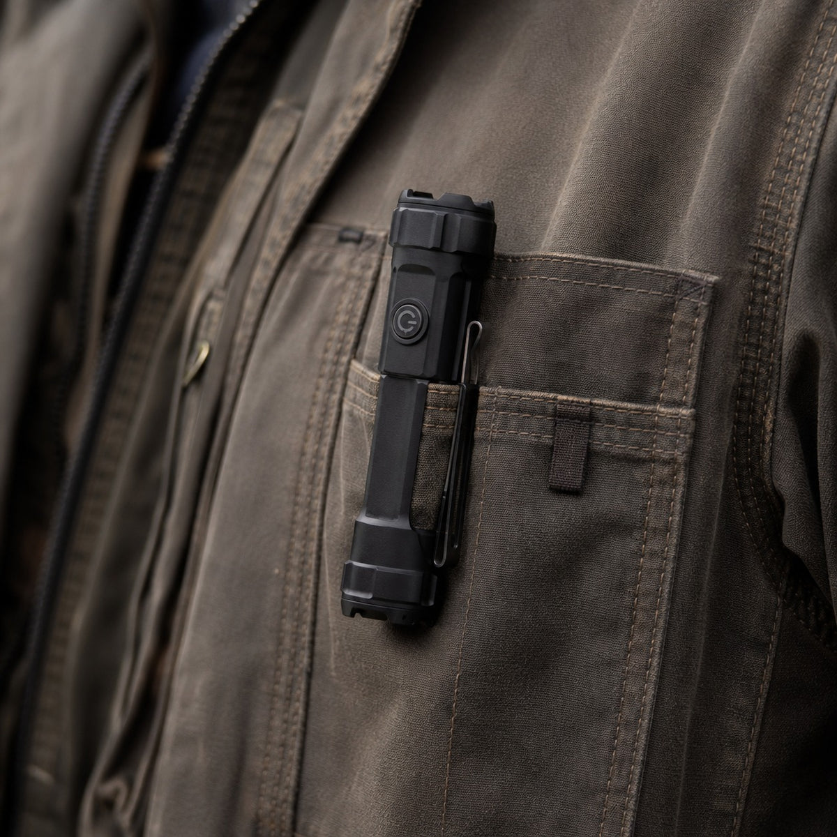 Tacright USB Flashlight clipped to a jacket pocket, seen close in daylight