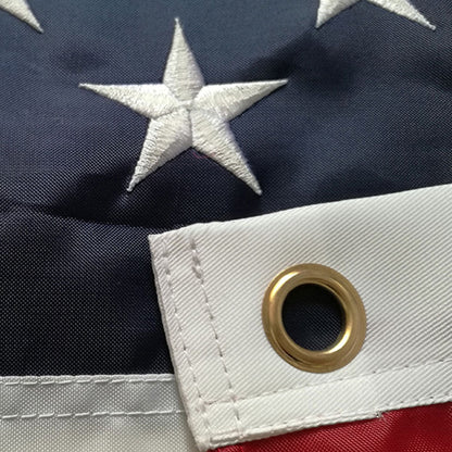 Close view of the white canvas header and brass grommet on the hoist edge