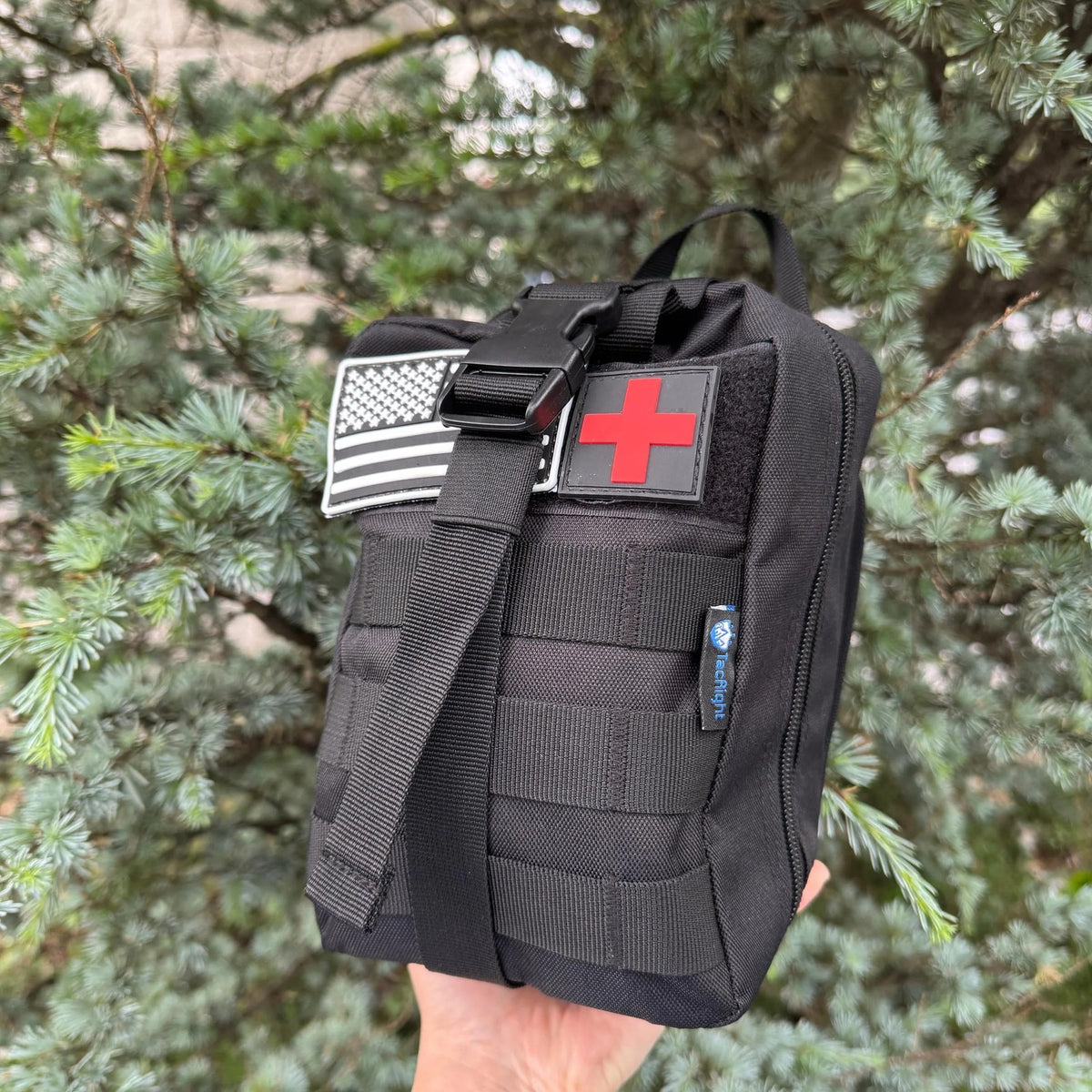 Trauma First Aid Kit held up to show its compact size